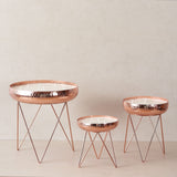 three rosegold different sized urlis with stand