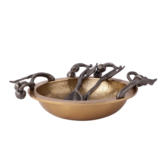 Golden bowl with serving spoons