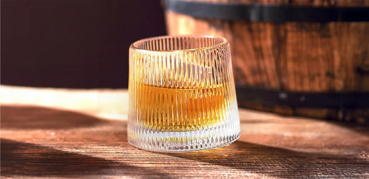 a whiskey glass with a drink in it
