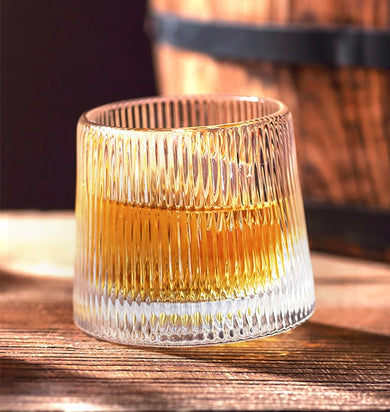 a whiskey glass with a drink in it