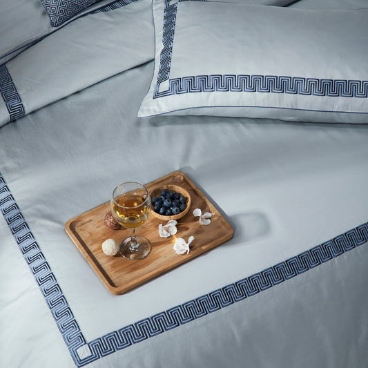 Light blue duvetcover & pillow cover on bed