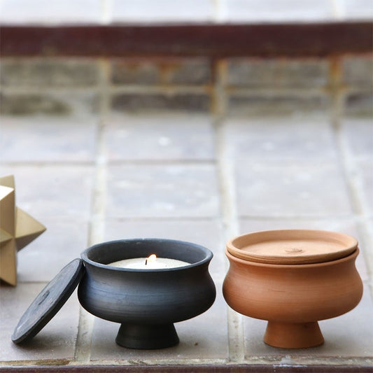 black and brown terracotta candle