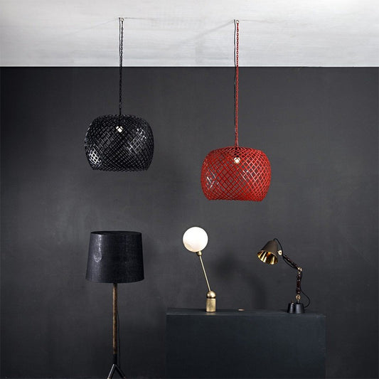 A room with two suspended cage pendant lights, two table lamps, and a floor lamp