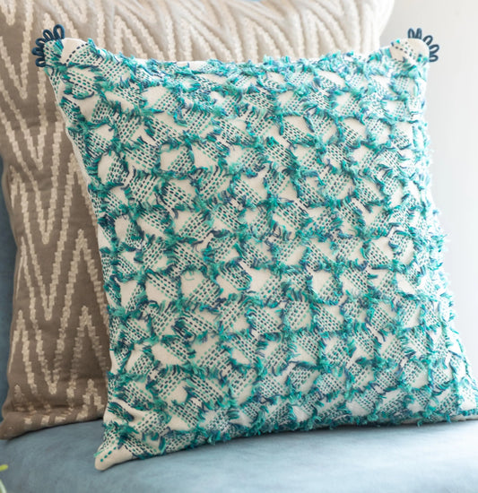 Teal cushion with embroidery