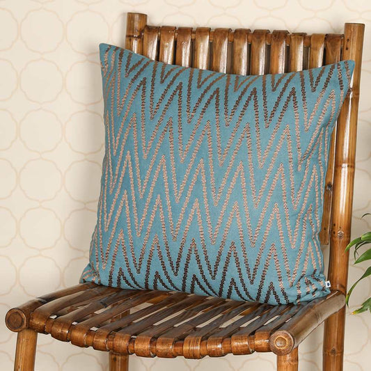 Teal throw pillow on wooden chair