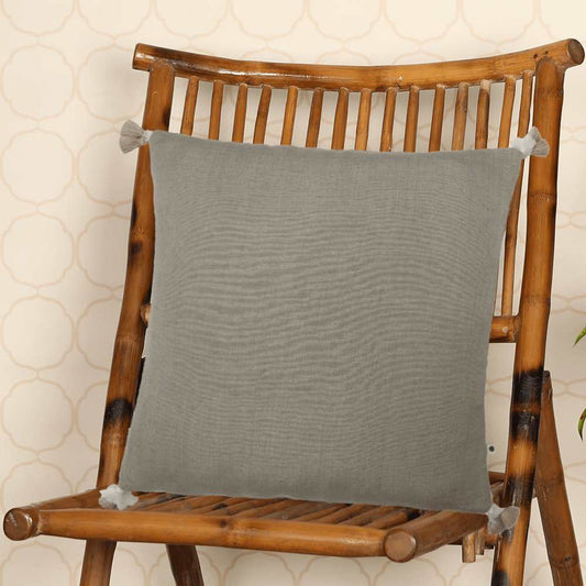 Grey throw pillow on wooden chair