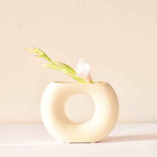 white ceramic half donut vase