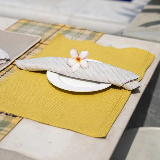 Yellow table napkin on white plate