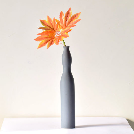Flute shaped grey vase with flower