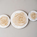 White marble disk with gold metal wall decor