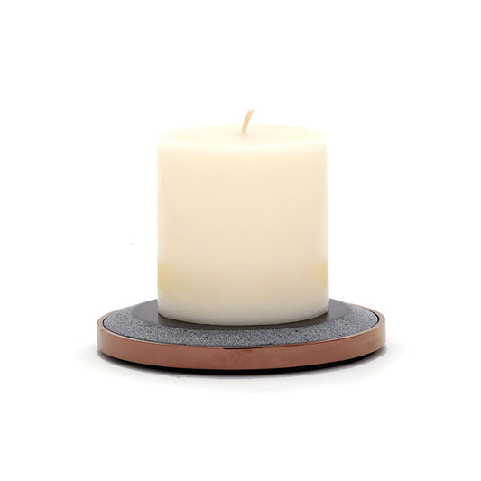 white candle on one black candle plate