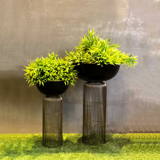 Two green plants on wired planters