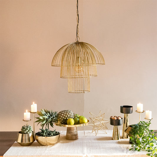 gold pendant lamp is hanging over the table