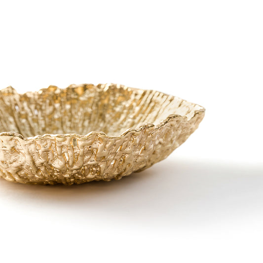 close up of triangular gold serving bowl
