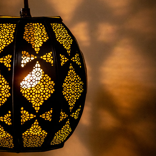 close up of a filigree pattern black pendant lamp