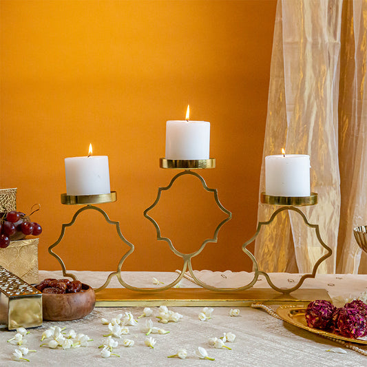 Three candle holders on a table