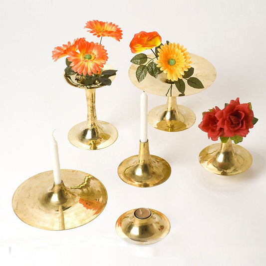 Three brass candlesticks and three vases of various sizes