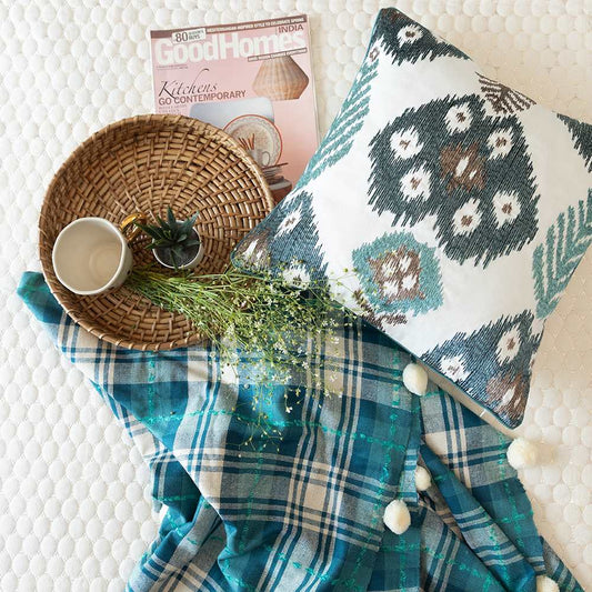 Blue cushion and throw with pom pom