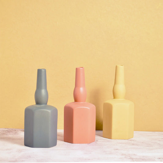 Three wine bottle vases in different colours
