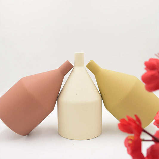 Three different coloured classic ceramic vases