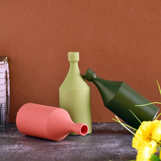 Three round bottle vases in different colours
