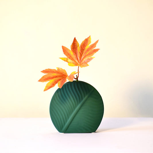 Ceramic flower vase in dark green
