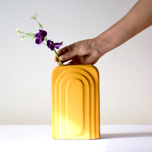 Rectangular yellow vase with flowers