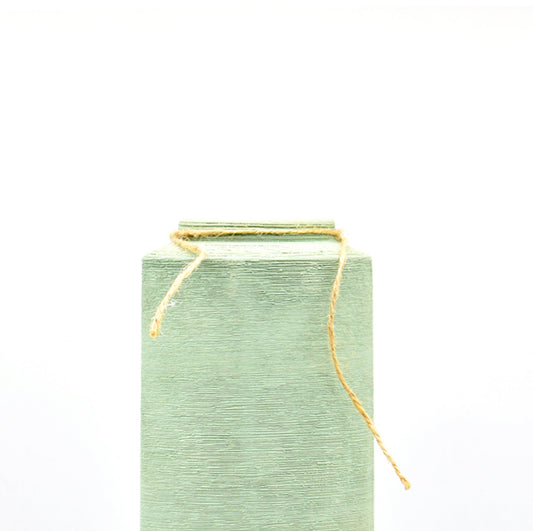 close-up of a long mint green vase