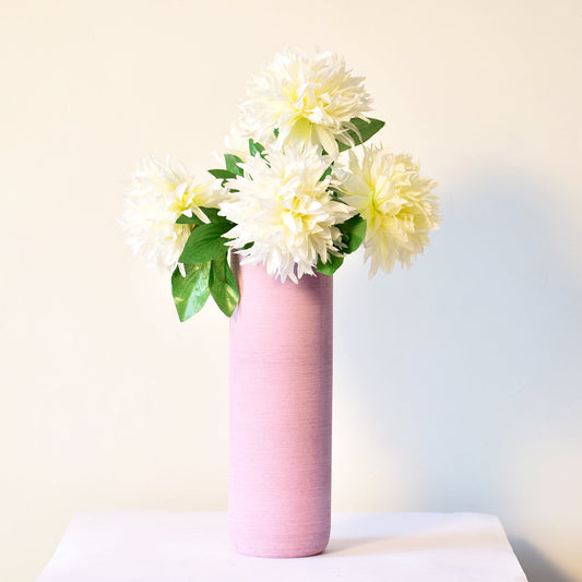 long vase with flowers in pink