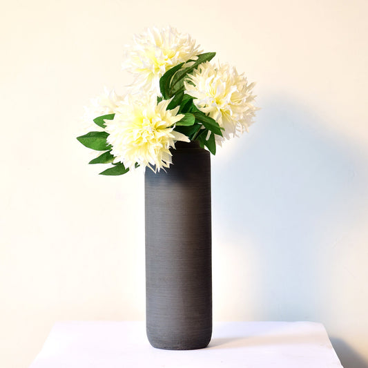 long black vase with flowers