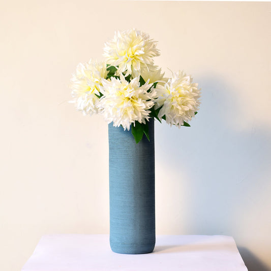 long bluish green vase with flowers