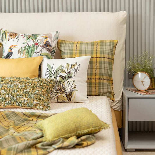 White and lime cushions and pillow on bed