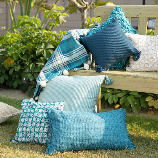 beautiful collection of cushions and throw in garden