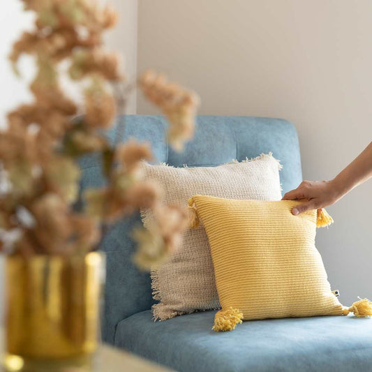 Soft throw pillow on blue sofa