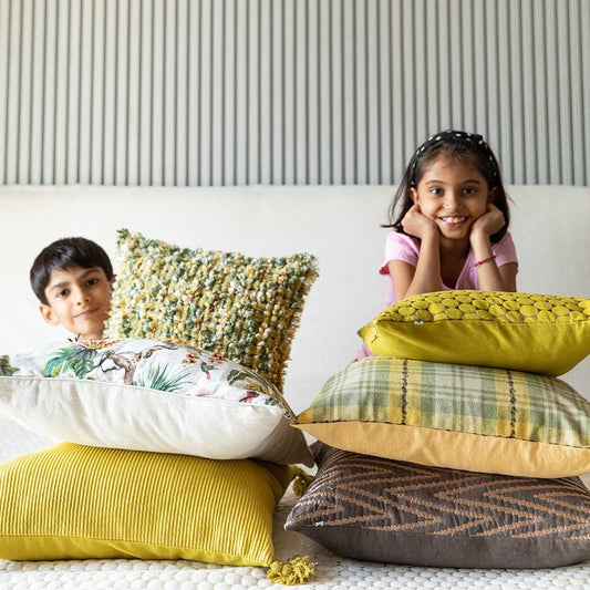 Happy kids with stacks of cushion