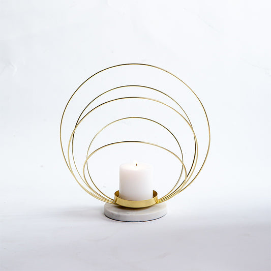 votive holder with a spiral pattern in gold and marble
