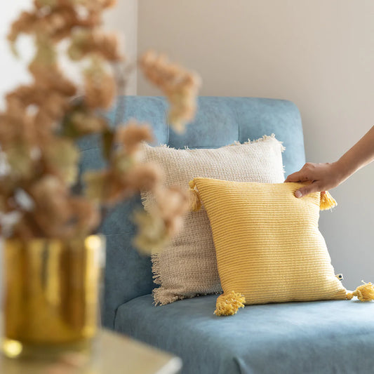 Yellow and white cushion cover on sofa