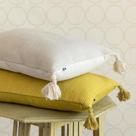 White and yellow cushions with tassels