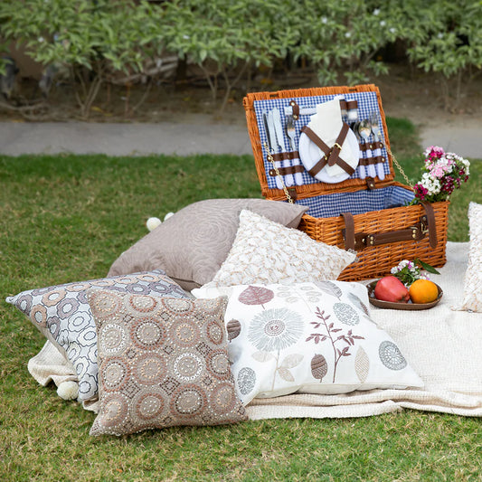 White brown pillows and picnic basket in garden