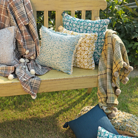 Multicolor cushion with throws in garden
