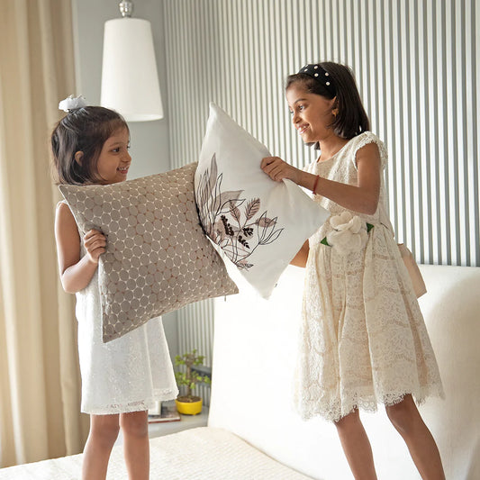 Young girls playying with cushion