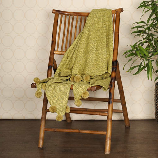 Yellow throw on wooden chair