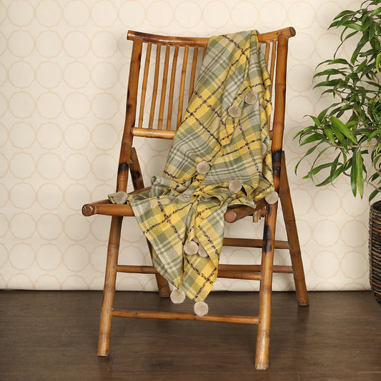 Green throw on wooden chair
